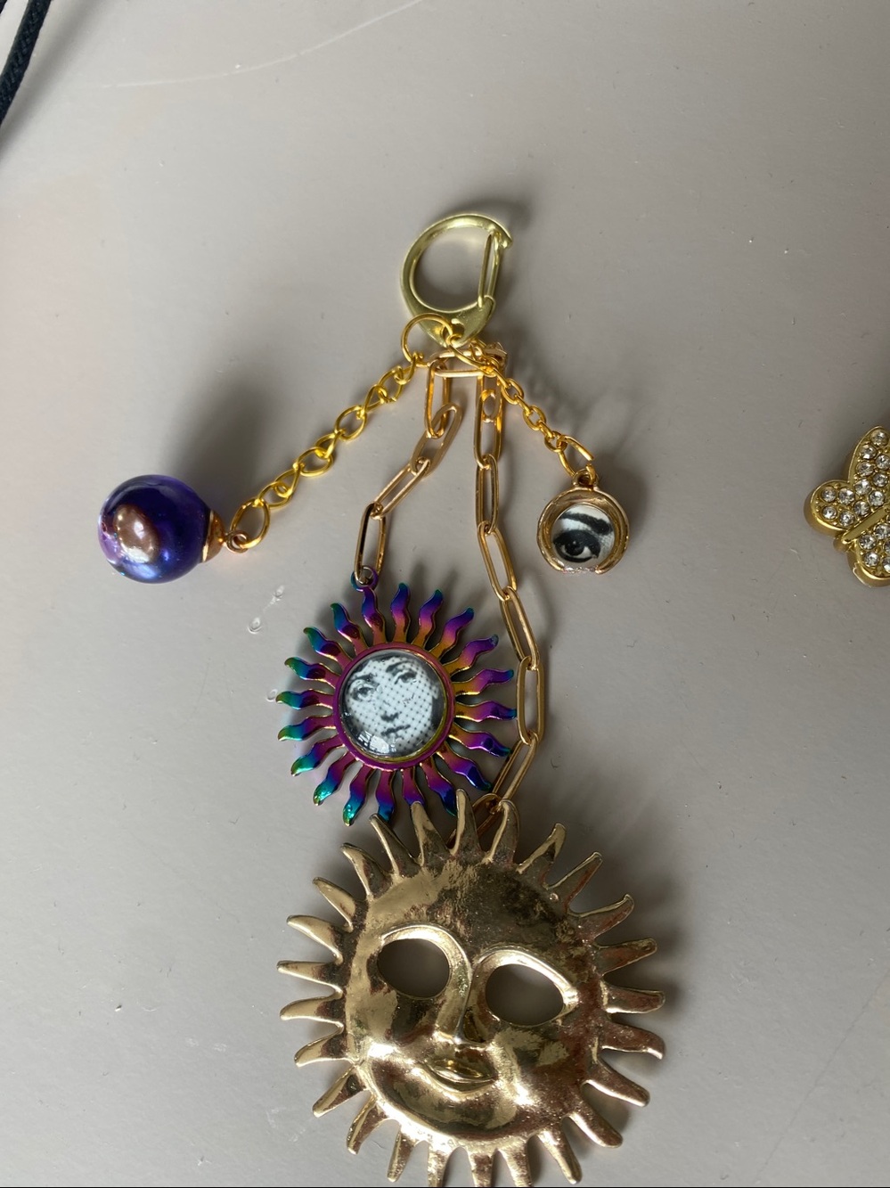 BAG CHARM FORNASETTI Sun Face Charm Keychain - Gold & Iridescent PURPLE